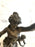 French bronze statue holding torch with a child by her side