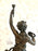 French bronze statue holding torch with a child by her side