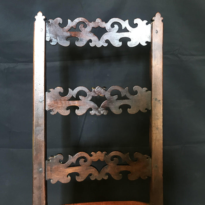 Antique carved walnut chair with orange upholstered seat 
