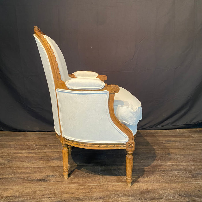 Pair of French Louis XVI Carved Walnut Armchairs or Bergere Chairs