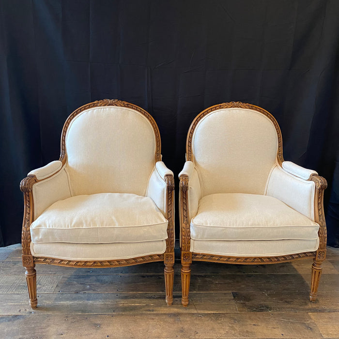 Pair of 19th Century French Louis XVI Carved Walnut Bergere Arm Chairs Newly Upholstered