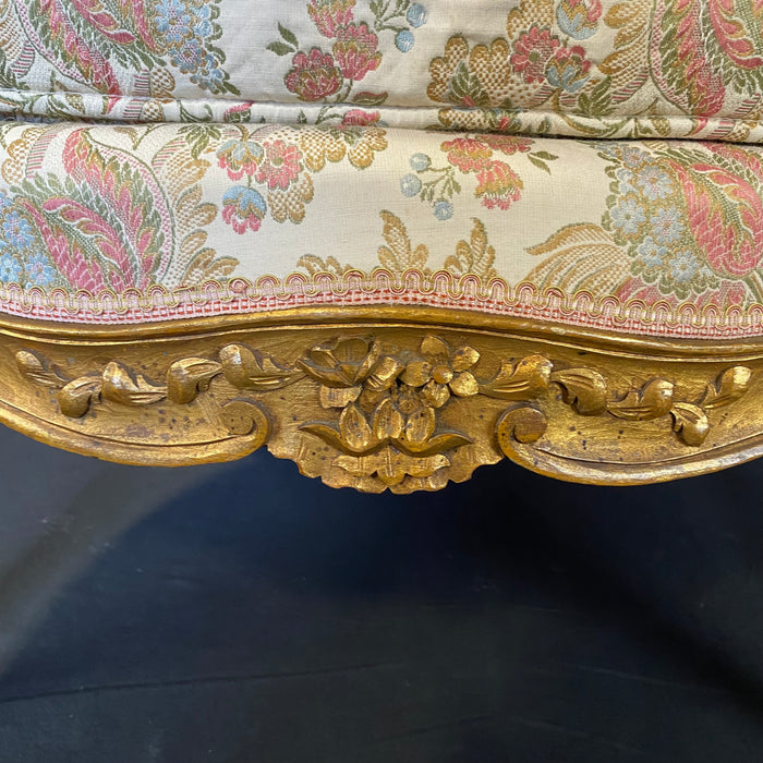 Pair of French Louis XV Giltwood Bergere Armchairs or Wingback Chairs with Carved Floral Motifs