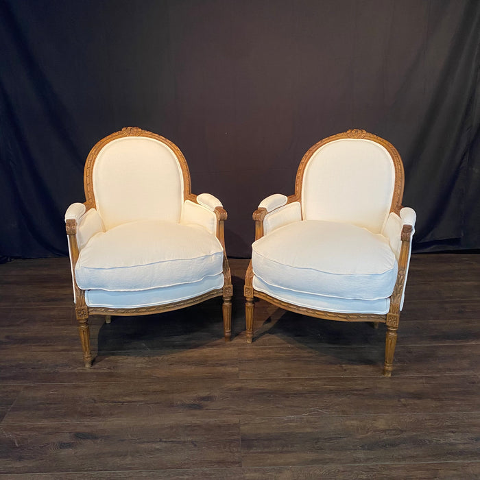 Pair of French Louis XVI Carved Walnut Armchairs or Bergere Chairs