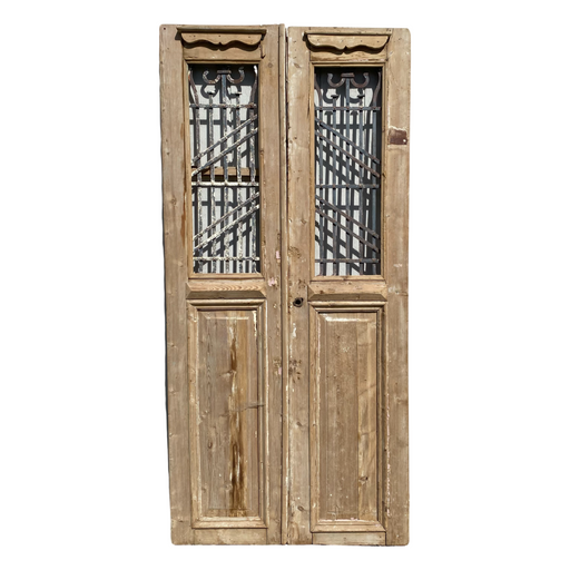 Pair of 19th Century French Paneled Doors with Intricate Wrought Iron Panels