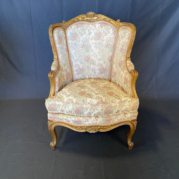 Pair of French Louis XV Giltwood Bergere Armchairs or Wingback Chairs with Carved Floral Motifs