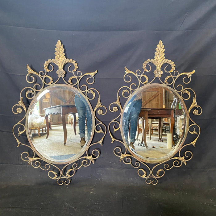 Pair of French Midcentury Fleur de Lis Scrolled Oval Beveled Wall Mirrors