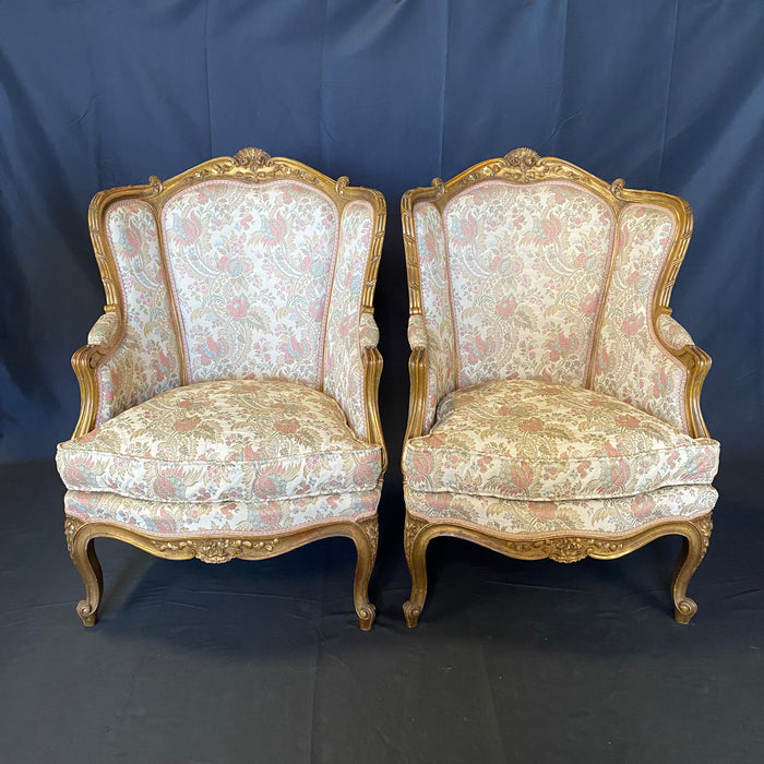 Pair of French Louis XV Giltwood Bergere Armchairs or Wingback Chairs with Carved Floral Motifs