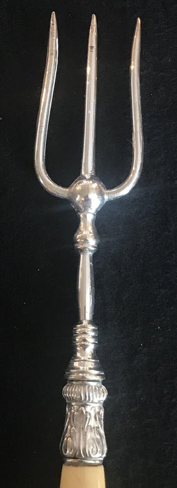 Antique silver bread fork with ornate detail