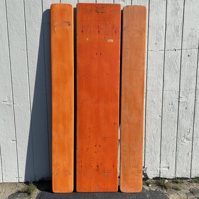 Picnic style orange painted wood folding table with two benches 