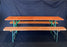 Picnic style orange painted wood folding table with two benches 