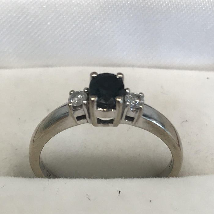 Antique engagement ring with a single sapphire and two diamonds 