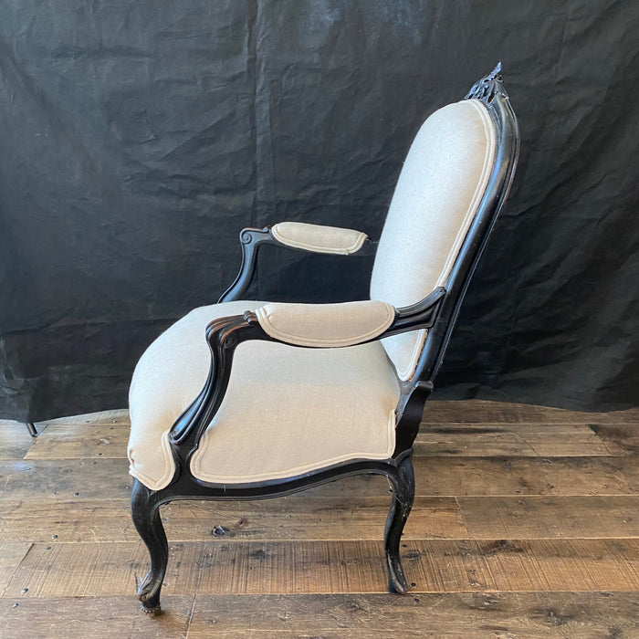 Antique carved ebony chair with new beige upholstery 