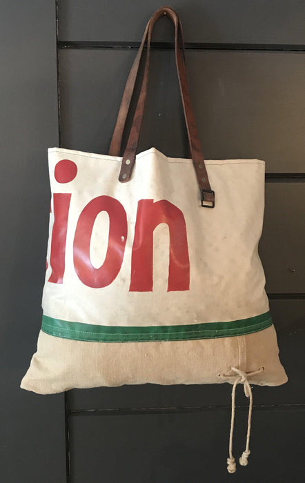 Vintage shoulder bag made from a vintage painted sign with leather handles