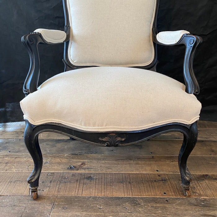 Antique carved ebony chair with new beige upholstery 