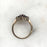 Vintage engagement ring of garnet stones in a flower design on a gold band 