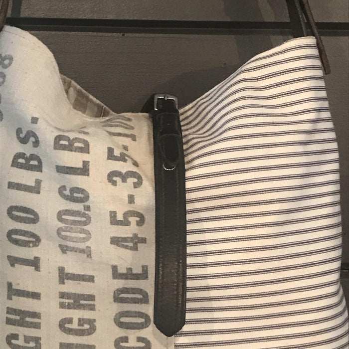 Vintage shoulder bag made from a flour sack with blue and white stripes and a leather strap 