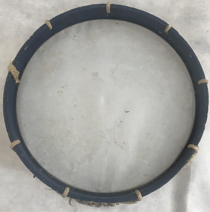 Antique brass drum with blue trim and a rope handle 