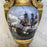 Antique gold vase with a hand painted image of a ship 