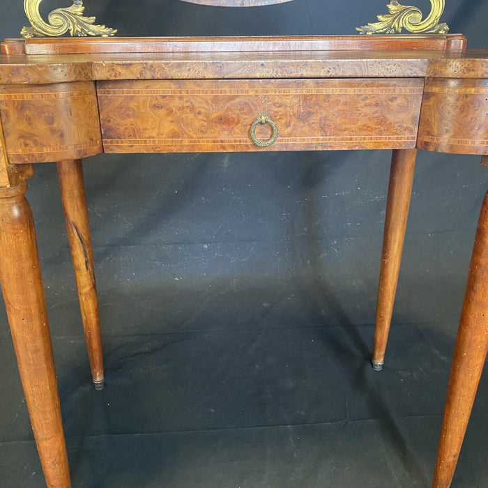 Antique burled walnut vanity with attached mirror and candelabras 