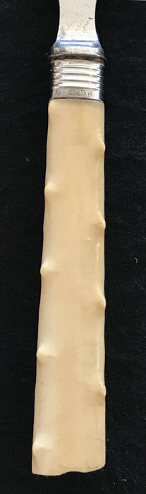 Antique silver bread form with a bone style handle