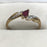 Vintage engagement ring with a ruby and diamonds on a gold band 