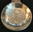 Antique small round silver spoon with a crest on the top handle