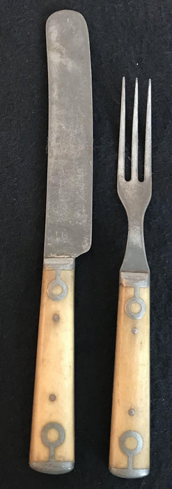 Antique silver fork and knife set with a bone handle