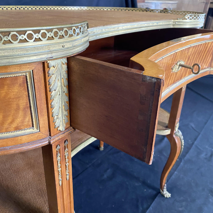 Antique burled walnut desk with brass details and a leather top 
