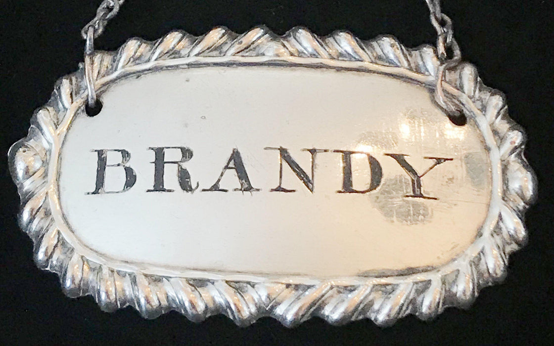 Antique silver brandy liquor label 