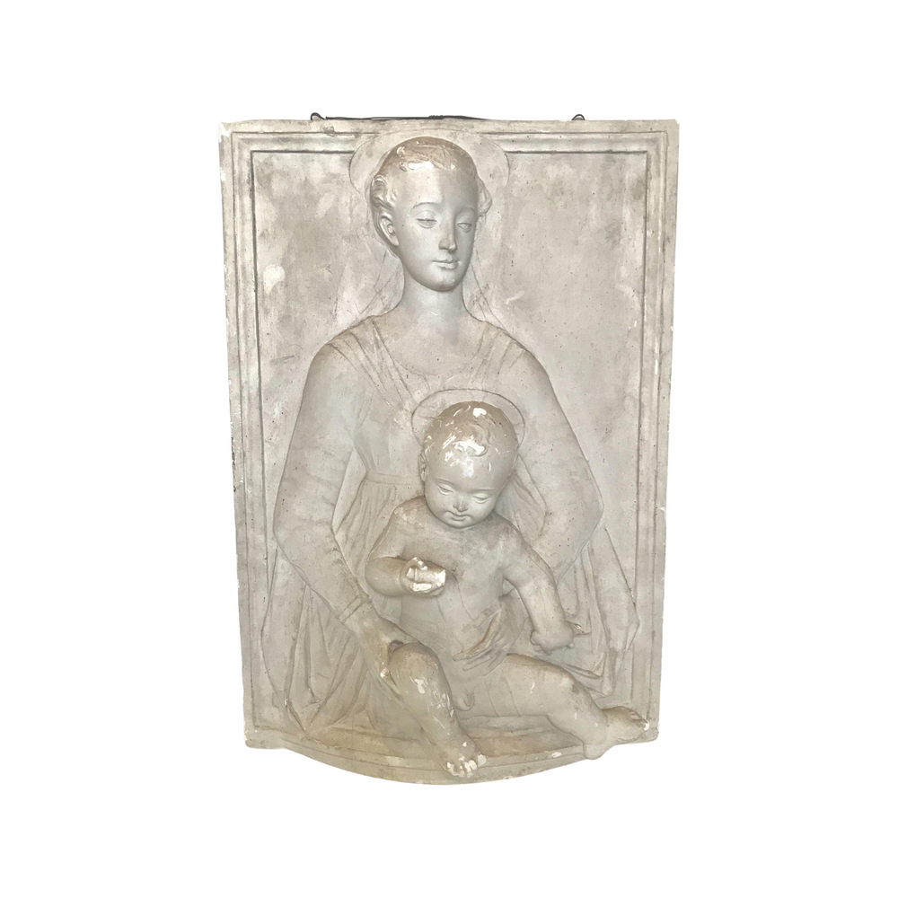 Antique white sculpture of a mother holding a child