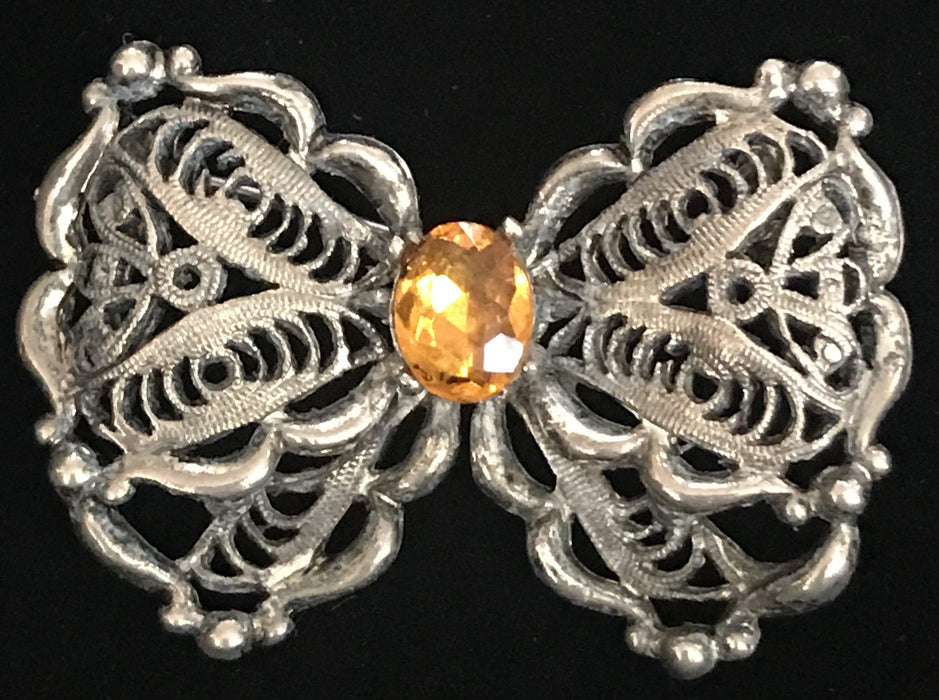 Antique silver butterfly brooch or pin with orange center stone 