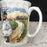 Antique white mug with gold rim and coat of arms design 
