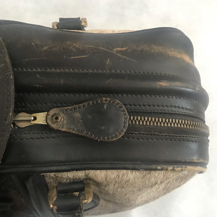 Antique cowhide suitcase with leather handles and buckle 