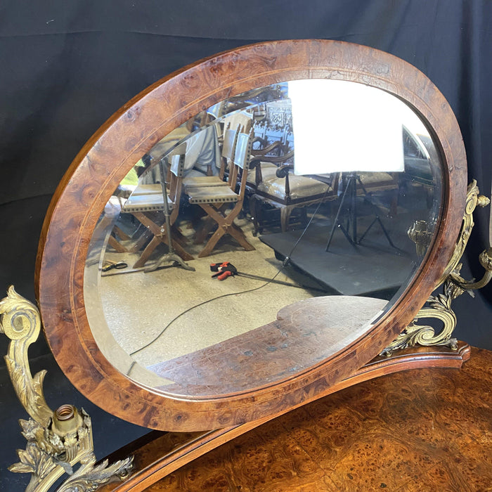 Antique burled walnut vanity with attached mirror and candelabras 
