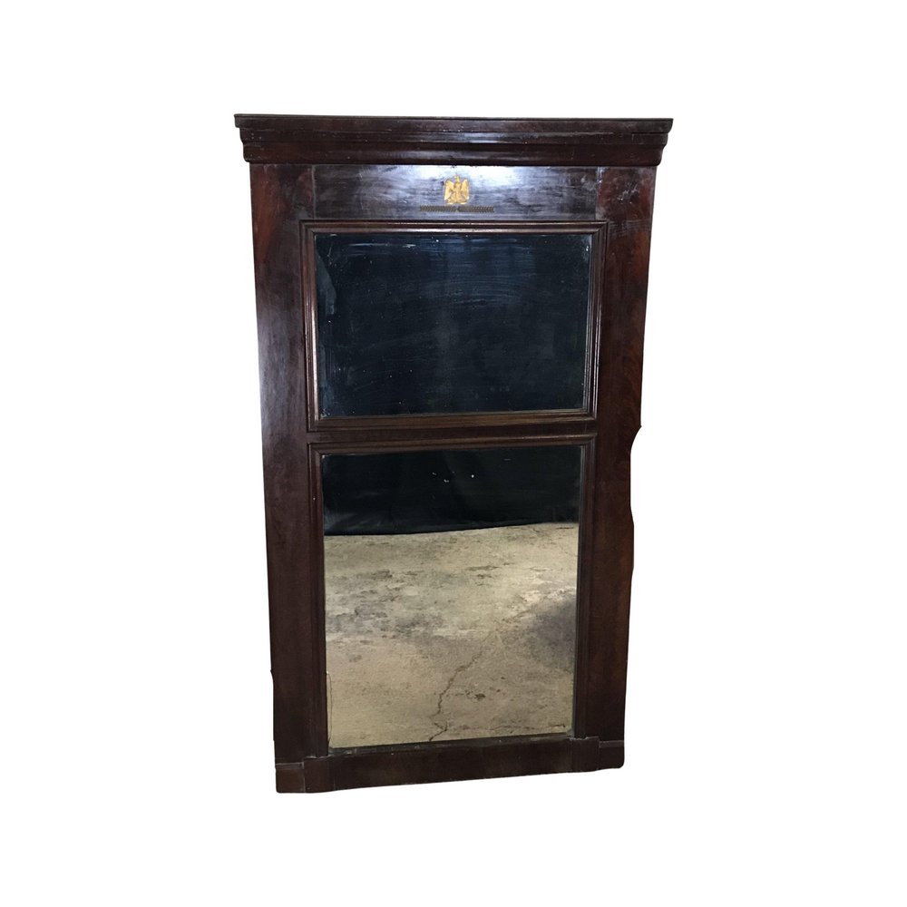 Antique dark wood mahogany mirror with a gold eagle detail on the top