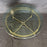 Antique round glass top coffee table with a brass base 