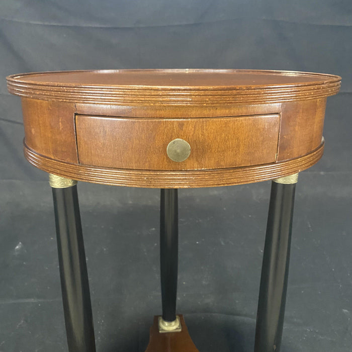 Antique walnut round nightstand or side table with ebony legs and bronze details 