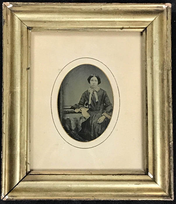Antique photo of a woman in a gold frame 