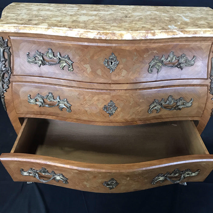 Antique dresser with a marquetry design and a marble top 