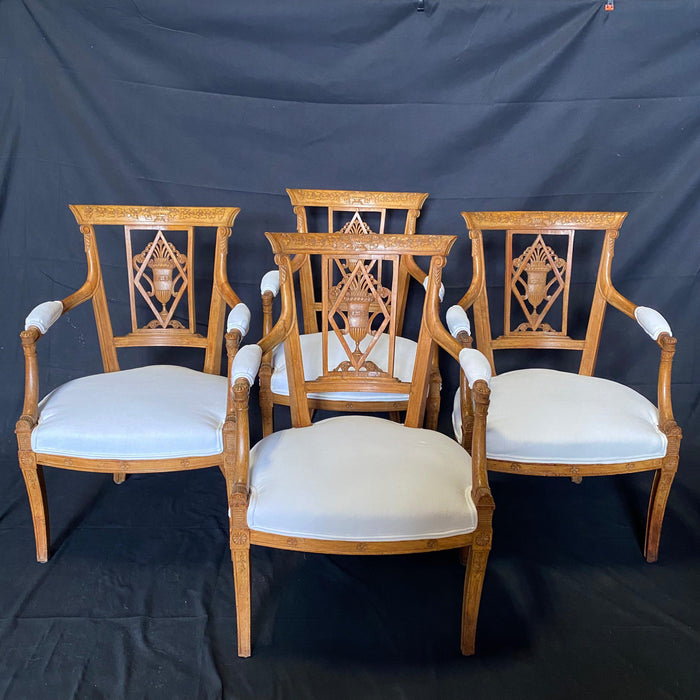 Set of Four 19th Century French Walnut Intricately Carved Neoclassical Arm Chairs