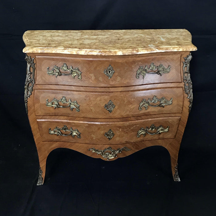 Antique dresser with a marquetry design and a marble top 