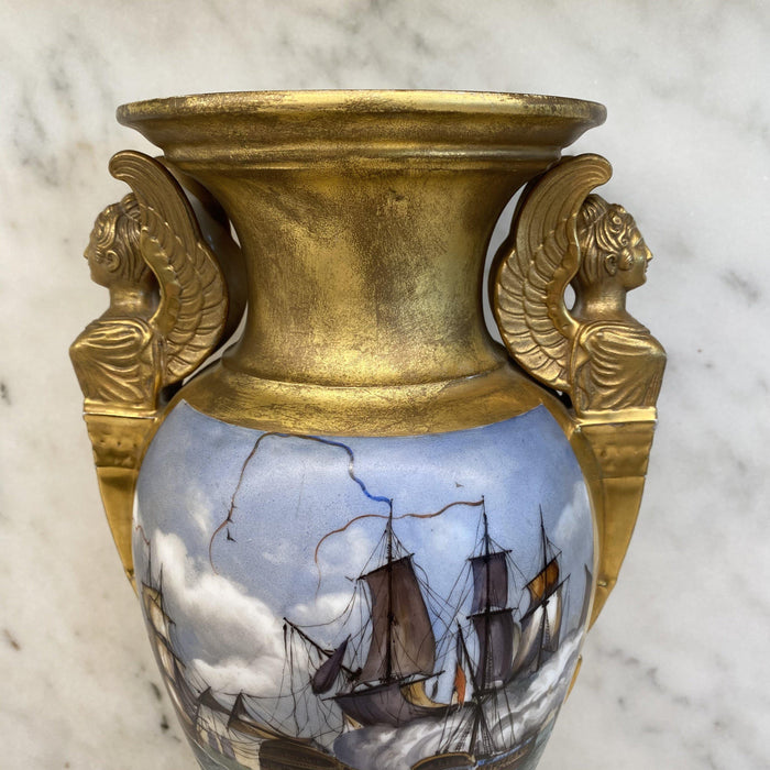 Antique gold vase with a hand painted image of a ship 