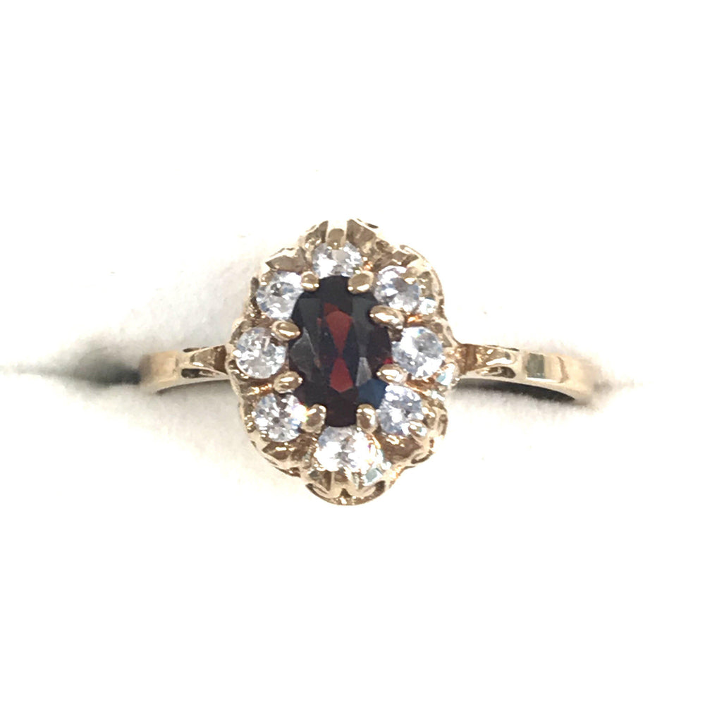 Vintage engagement ring with garnet center and white sapphires