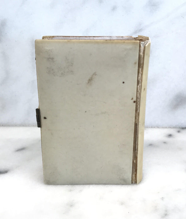 Antique French mini prayer book with a silver crest on the front and gold gilt page edges