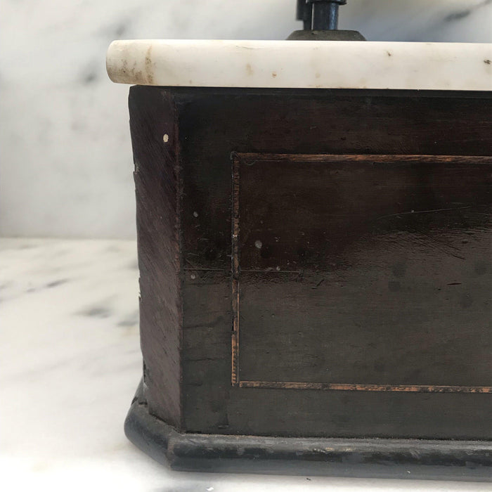 Antique black wooden scale with a white marble top and bronze scales 