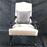 Antique carved armchair on casters with new upholstery 