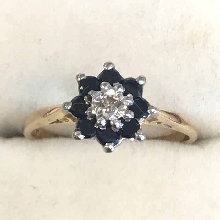 Vintage gold band ring with a sapphire and diamond cluster 