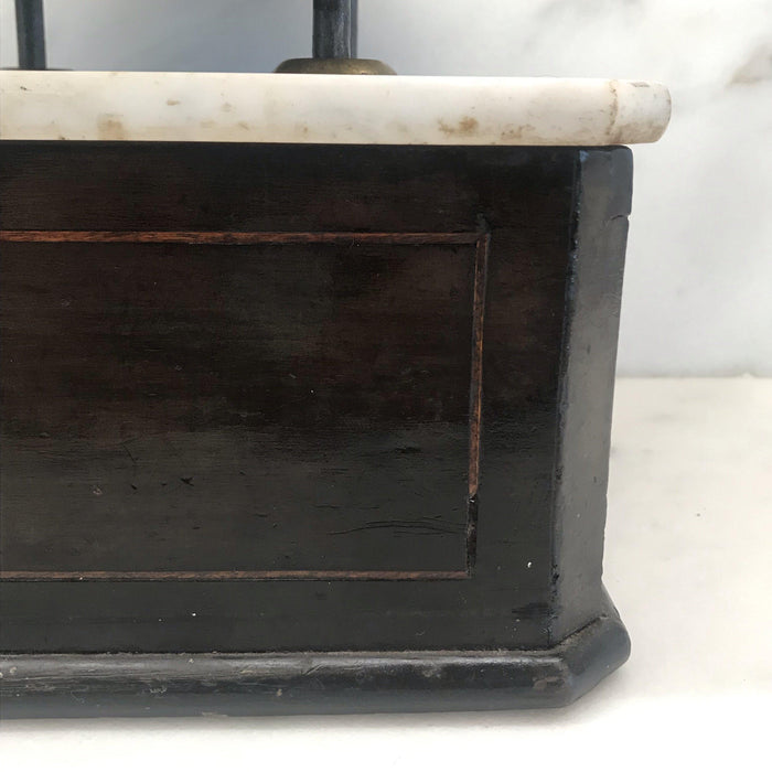 Antique black wooden scale with a white marble top and bronze scales 