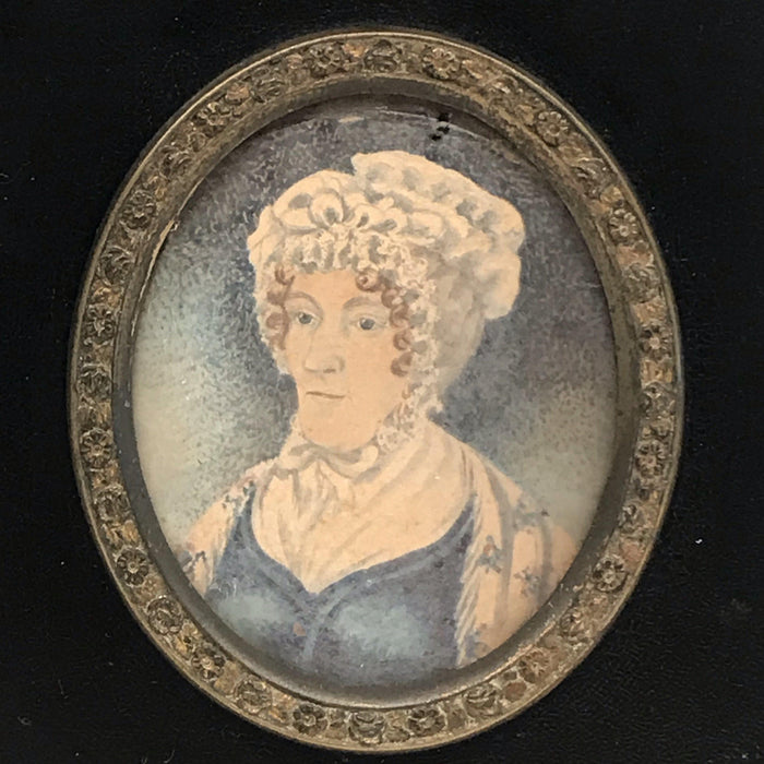 Antique painting of a woman in a black frame with gold details