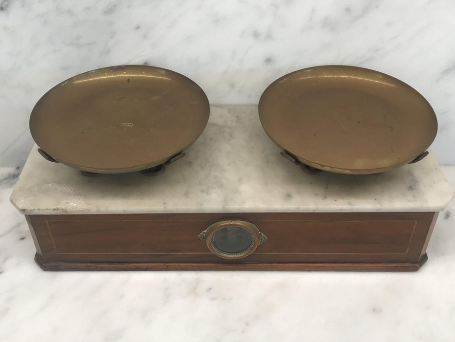 Antique wooden scale with a white marble top and bronze scales